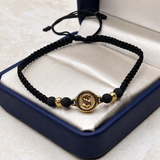 Pulsera tejida Herraje signo peso, balines #4 y neoprenos negros Oro amarillo 18k 0,71 Gr